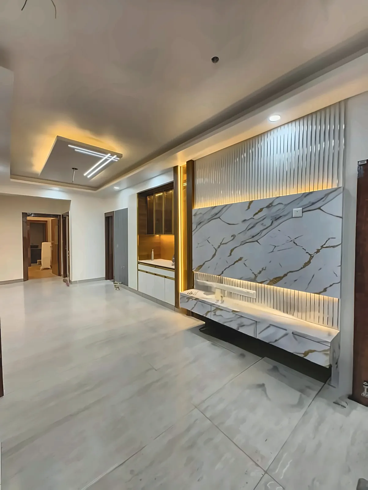 Living room interior by Livibi with a marble and fluted-glass TV feature wall